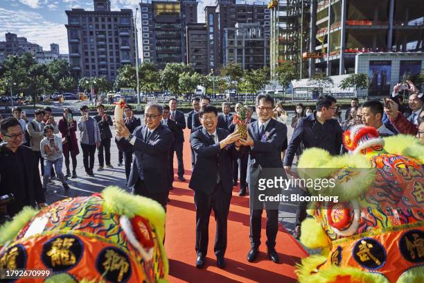 Young Liu, chairman of Hon Hai Precision Industry Co., center, arrives at the Taiwan Stock Exchange for the listing ceremony of Foxtron Vehicle...