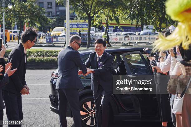 Young Liu, chairman of Hon Hai Precision Industry Co., center, arrives at the Taiwan Stock Exchange for the listing ceremony of Foxtron Vehicle...
