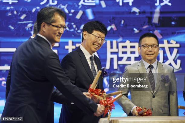 Young Liu, chairman of Hon Hai Precision Industry Co., center, bangs the opening drum during the listing ceremony of Foxtron Vehicle Technologies...