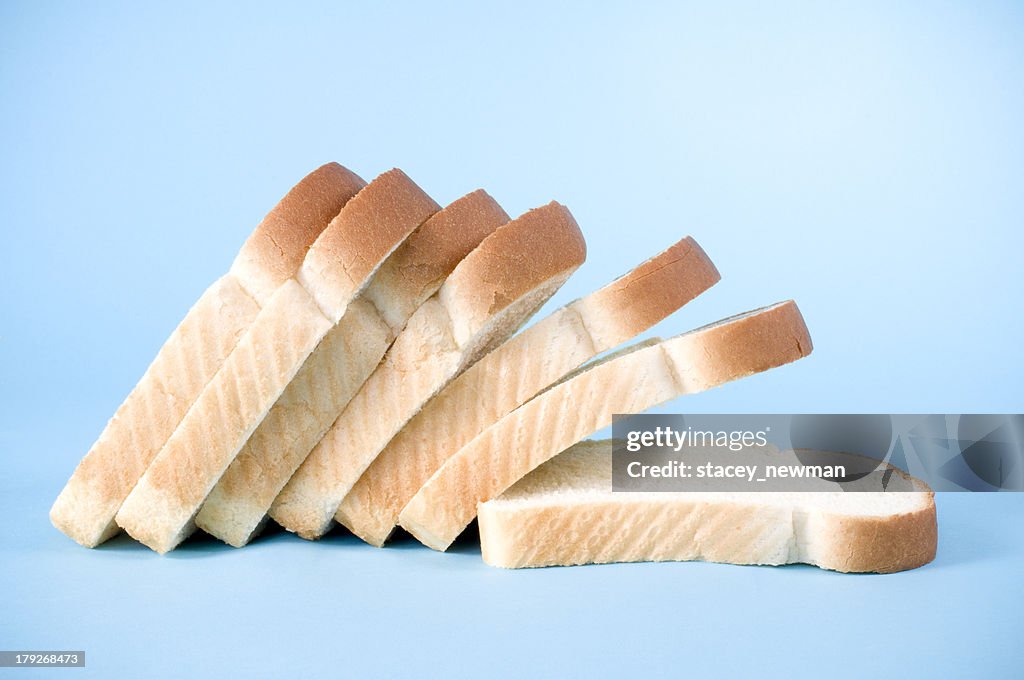 Slices of white bread on a blue background
