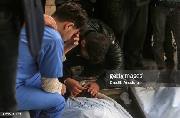 Relatives of the Palestinians died in Israeli attacks, mourn as they take the bodies from the morgue of An-Najjar Hospital for the funeral ceremony...