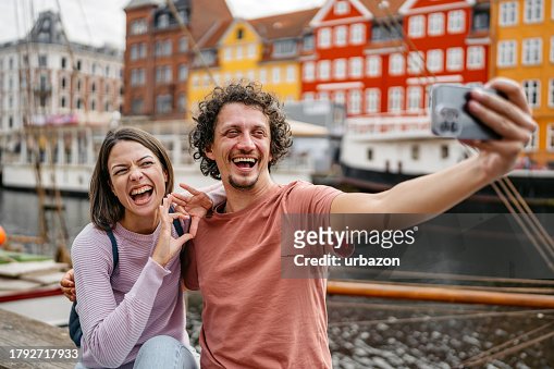 Young Couple Taking Selfies In Nyhavn Canal In Copenhagen In Denmark ...