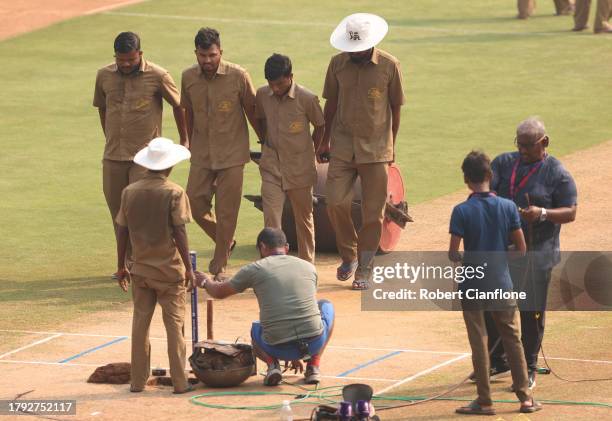 Grounds keepers prepare the pitch during a New Zealand training session at the ICC Men's Cricket World Cup India 2023 at Wankhede Stadium on November...