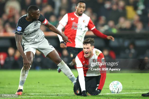 Santiago Gimenez of Feyenoord is tackled by Bruno Martins Indi of AZ during the Dutch Eredivisie match between Feyenoord and AZ at Stadion Feyenoord...