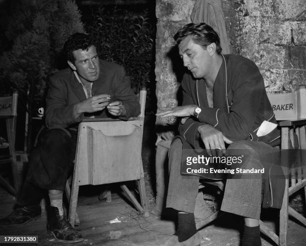 Irish actor Kieron Moore and American actor Robert Mitchum during the filming of 'The Angry Hills' at MGM British Studios in Borehamwood,...