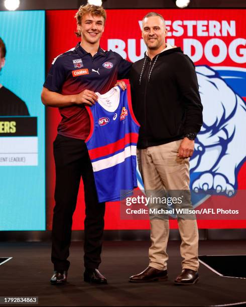 Ryley Sanders is seen with Lindsay Gilbee after being selected at number six by the Western Bulldogs during the 2023 AFL Draft at Marvel Stadium on...