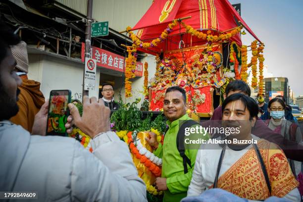 Taiwan Indian residents pose for a snap shot in front of the chariot carrying the sacred trimurti, in occasion of the Rata Yatra festival, a Hindu...
