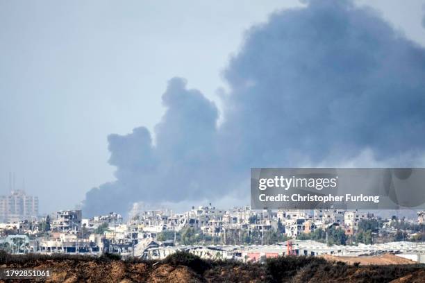 In this photograph taken near the Israeli border with the Gaza Strip a large ploom of smoke rises over Gaza City on November 14, 2023 near Sderot,...