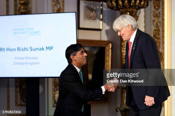 British Minister of State for Development Andrew Mitchell shakes hands with Prime Minister Rishi Sunak after delivering opening remarks during the...