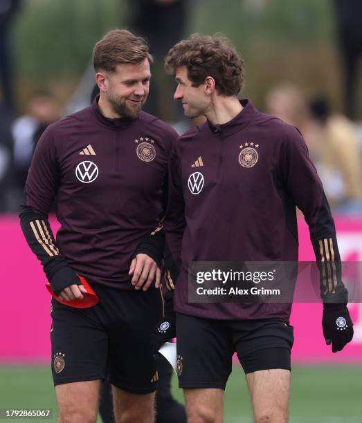 Niclas Fuellkrug and Thomas Mueller interact during a training session of the German national team at DFB-Campus on November 14, 2023 in Frankfurt am...