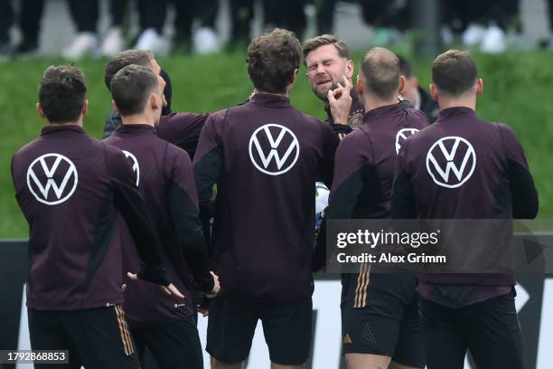 Niclas Fuellkrug interacts with teammates during a training session of the German national team at DFB-Campus on November 14, 2023 in Frankfurt am...