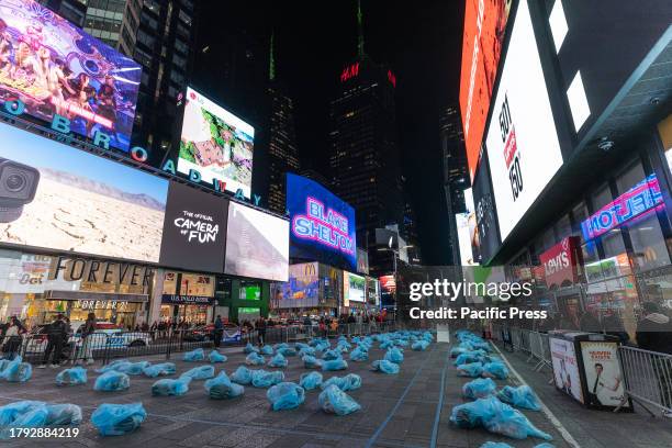 People put out plastic bags with sleeping bags, masks, blankets etc in preparation for a sleep out night on Times Square as part of Covenant House...