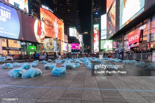 People put out plastic bags with sleeping bags, masks, blankets etc in preparation for a sleep out night on Times Square as part of Covenant House...