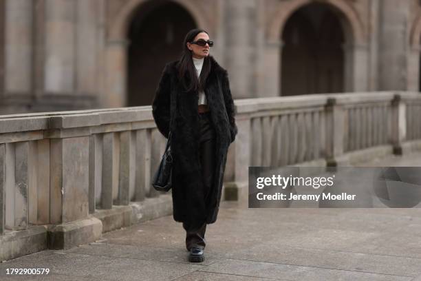 Anna Winter seen wearing Bottega Veneta black sunglasses, Gant dark brown fake fur long coat, The Frankie Shop cream white high neck cropped knit...