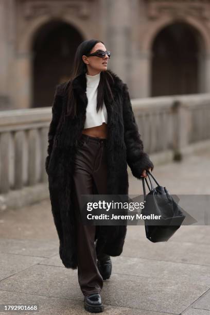 Anna Winter seen wearing Bottega Veneta black sunglasses, Gant dark brown fake fur long coat, The Frankie Shop cream white high neck cropped knit...