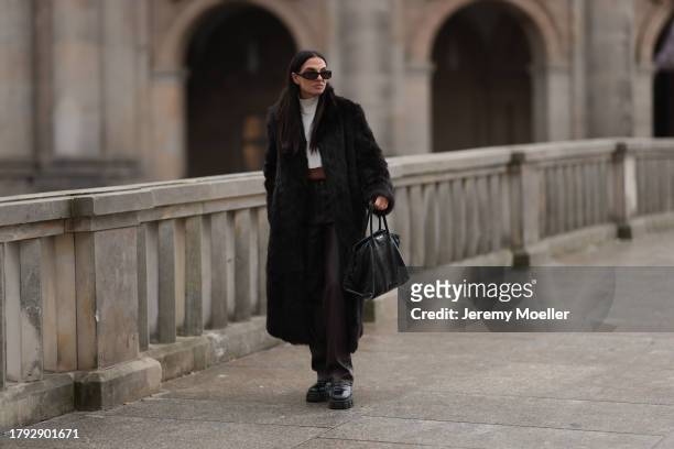 Anna Winter seen wearing Bottega Veneta black sunglasses, Gant dark brown fake fur long coat, The Frankie Shop cream white high neck cropped knit...