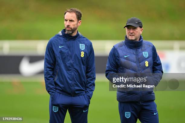 Gareth Southgate, Head Coach of England, and Steve Holland, Assistant Head Coach of England, look on during an England Men Training Session at St...