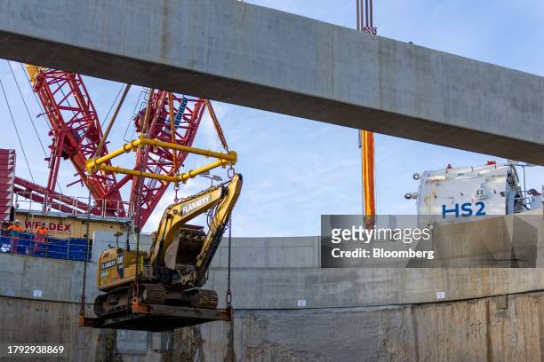 Crane removes an excavator from the HS2 Victoria Road Crossover Box of the High Speed Two HS2 Ltd. Railway development in London, UK, on Friday, Nov....
