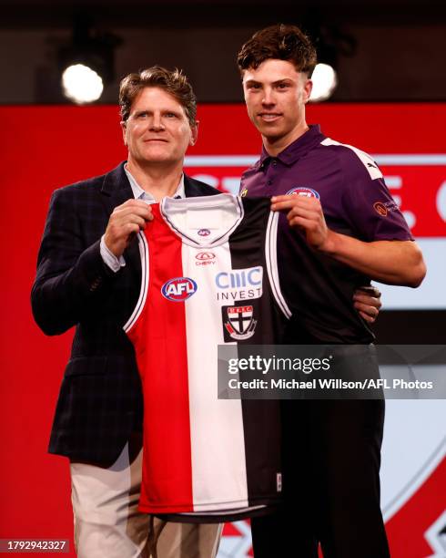 Darcy Wilson is seen with Robert Harvey after being selected at number 18 by St Kilda during the 2023 AFL Draft at Marvel Stadium on November 20,...