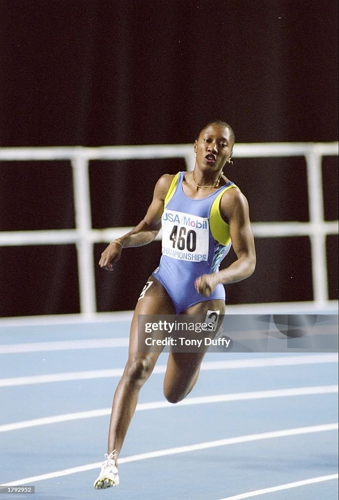 Chryste Gaines runs around the track during the National Indoor... News