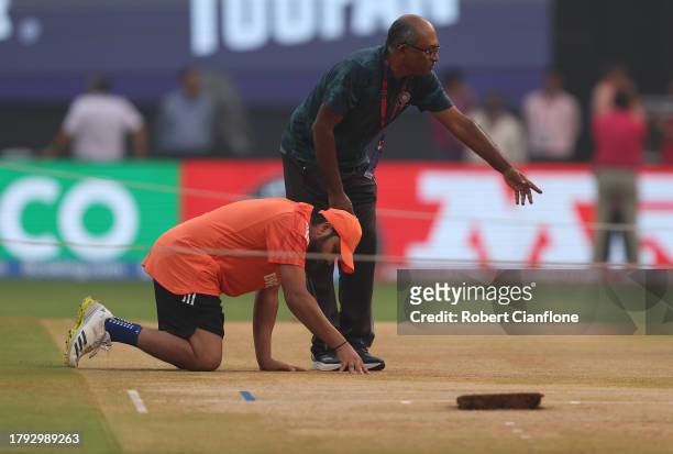 Rohit Sharma of India inspects the pitch during a India training session at the ICC Men's Cricket World Cup India 2023 at Wankhede Stadium on...
