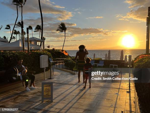 People observe a sunset over Wailea Beach at Four Seasons Resort Maui at Wailea hotel, Kihei, Hawaii, July 16, 2023.