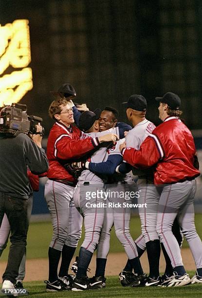 Outfielder Tony Fernandez of the Cleveland Indians is mobbed by his teammates during game six of the American League Championship against the...