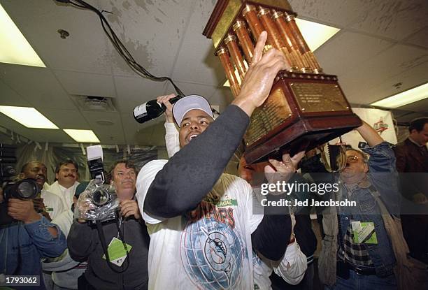 Third baseman Bobby Bonilla of the Florida Marlins holds a trophy after game six of the National League Championship against the Atlanta Braves at...