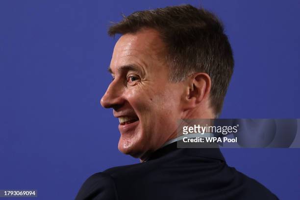 Britain's Chancellor of the Exchequer Jeremy Hunt waits for the start of a speech by the prime minister at a college in north London on November 20,...