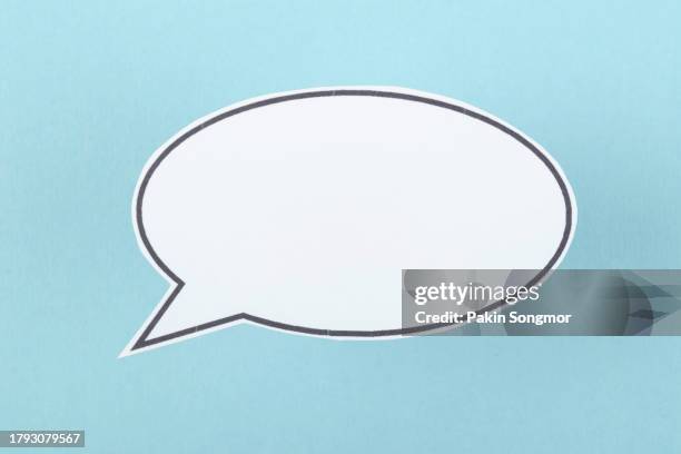 the words talking and speaking are conveyed by a speech bubble with copy space on a blue background. - speech bubbles stock pictures, royalty-free photos & images