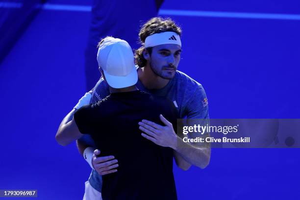 Stefanos Tsitsipas of Greece and Holger Rune of Denmark interact by the net after Stefanos Tsitsipas of Greece retired during the Men's Singles Round...
