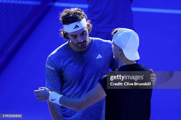Stefanos Tsitsipas of Greece looks dejected as he interacts with Holger Rune of Denmark after retiring in the Men's Singles Round Robin match on day...