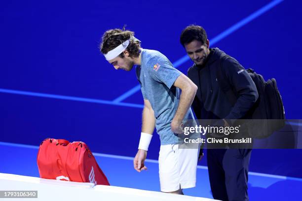 Stefanos Tsitsipas of Greece looks dejected after retiring in the Men's Singles Round Robin match against Holger Rune of Denmark on day three of the...