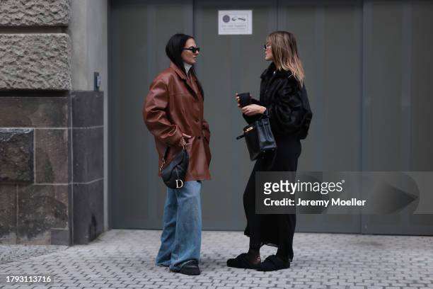 Anna Winter wears Celine black sunglasses, The Frankie Shop cream white high neck cropped knit sweater, Source Unknown brown oversized leather blazer...