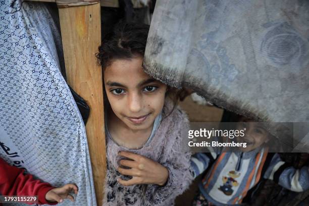Children in a temporary shelter in a camp for displaced Palestinians near the Shuhada Al-Aqsa hospital in Deir al-Balah, Gaza, on Monday, Nov. 13,...