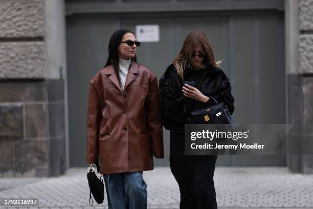 Anna Winter wears Celine black sunglasses, The Frankie Shop cream white high neck cropped knit sweater, Source Unknown brown oversized leather blazer...