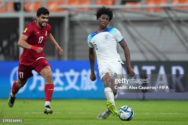Josh-Kofi Acheampong of England is challenged by Reza Ghandipour of IR Iran during the FIFA U-17 World Cup Group C match between England and IR Iran...