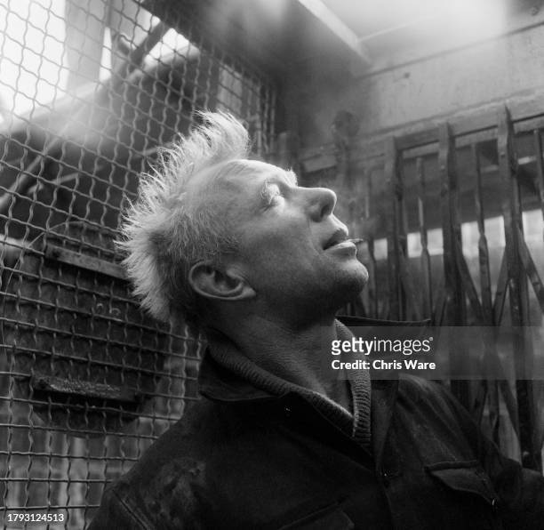 Construction worker looking up during a cigarette break at Northfleet Power Station in Kent, May 1959.