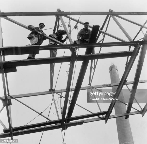 Workmen standing on girders above the pump chamber during the construction of Northfleet Power Station in Kent, May 1959.