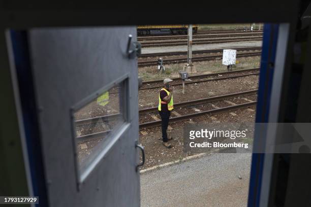 Worker makes a phone call outside a locomotive at the Transnet SOC Ltd. Sentrarand depot, in the Benoni district of Gauteng, South Africa, on Friday,...