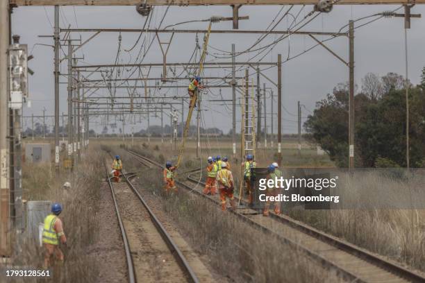 Workers repair sabotaged electrical cables on the central corridor rail freight line, between Sentrarand depot and Pyramid South depot, in Gauteng,...