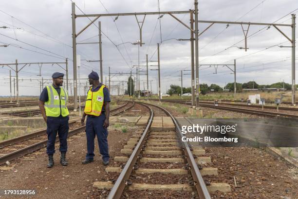 Private security guards patrol the railway lines at the Transnet SOC Ltd. Sentrarand depot, in the Benoni district of Gauteng, South Africa, on...