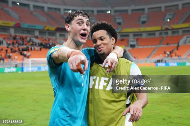 Tommy Setford and Ethan Nwaneri of England celebrate after the team's victory during the FIFA U-17 World Cup Group C match between England and IR...