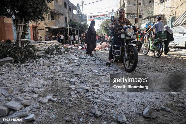 Palestinians cross blast rubble following an Israeli military strike on a market in Deir al-Balah, Gaza, on Monday, Nov. 13, 2023. While Israel has...