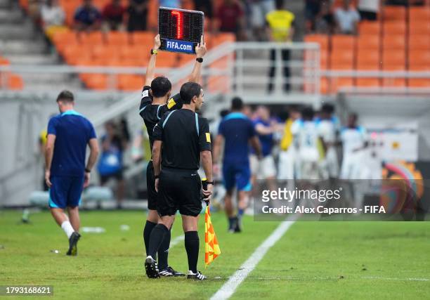 The assistant referee holds up the LED board to show 7 minutes of additional time during the FIFA U-17 World Cup Group C match between England and IR...