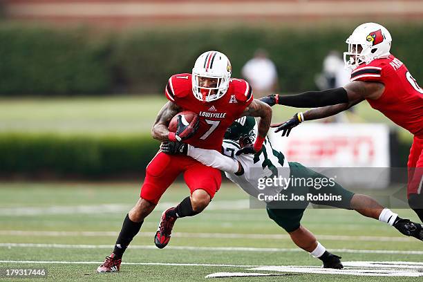 Damian Copeland of the Louisville Cardinals tries to break a tackle after a reception against the Ohio Bobcats during the game at Papa John's...