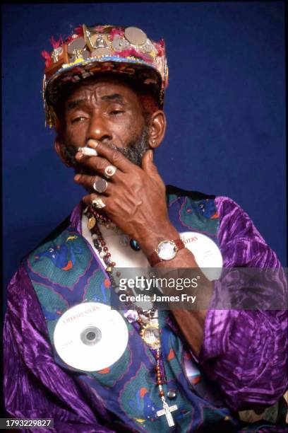 Jamaican record producer and dub reggae pioneer, Lee 'Scratch' Perry, wearing an outfit decorated with compact discs, Notting Hill Gate, London, 2006.