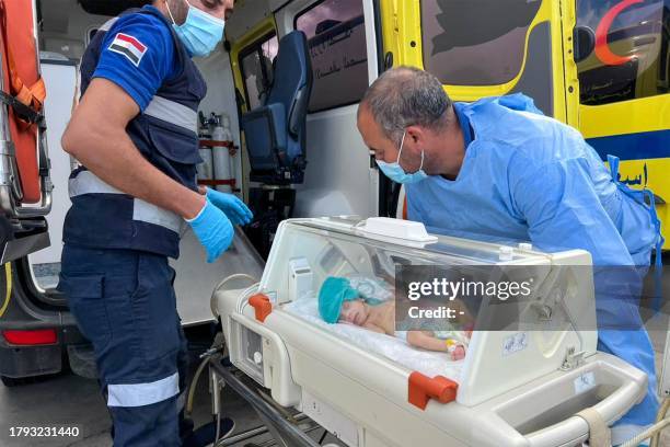 Egyptian medics wheel a premature Palestinian baby evacuated from Gaza to an ambulance on the Egyptian side of the Rafah border crossing with the...