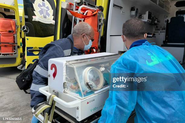 Egyptian medics wheel a premature Palestinian baby evacuated from Gaza to an ambulance on the Egyptian side of the Rafah border crossing with the...