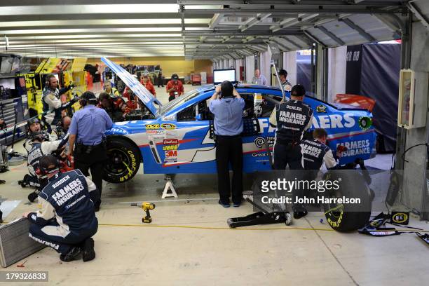 The Farmers Insurance Chevrolet, driven by Kasey Kahne, receives repairs after an on track incident during the NASCAR Sprint Cup Series AdvoCare 500...